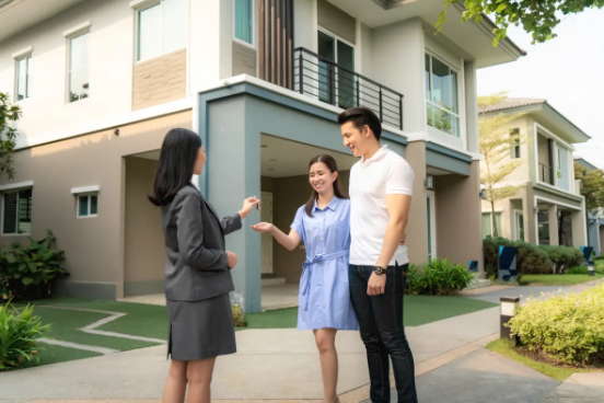 Wa We Property Management handing keys to a happy couple at a Property For Lease in Stamford, highlighting trusted rental property services